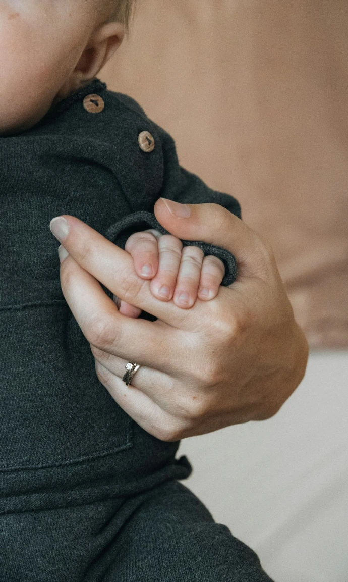 A woman holding a baby in her arms
